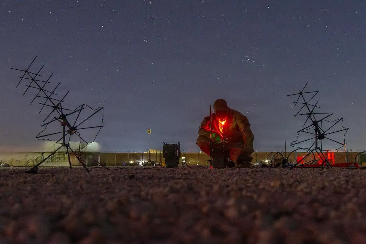 A soldier communicates over radio frequencies